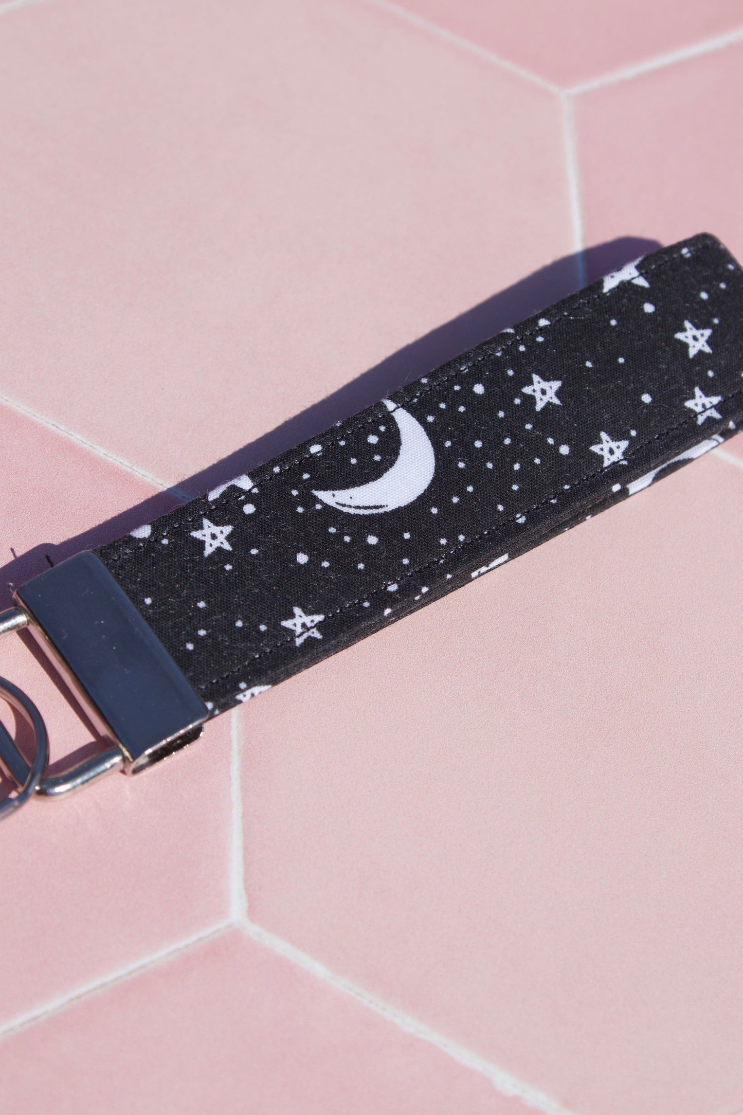 Sew Much Love black cotton wristlet keychain with white starry night and moon print. Features silver hardware.