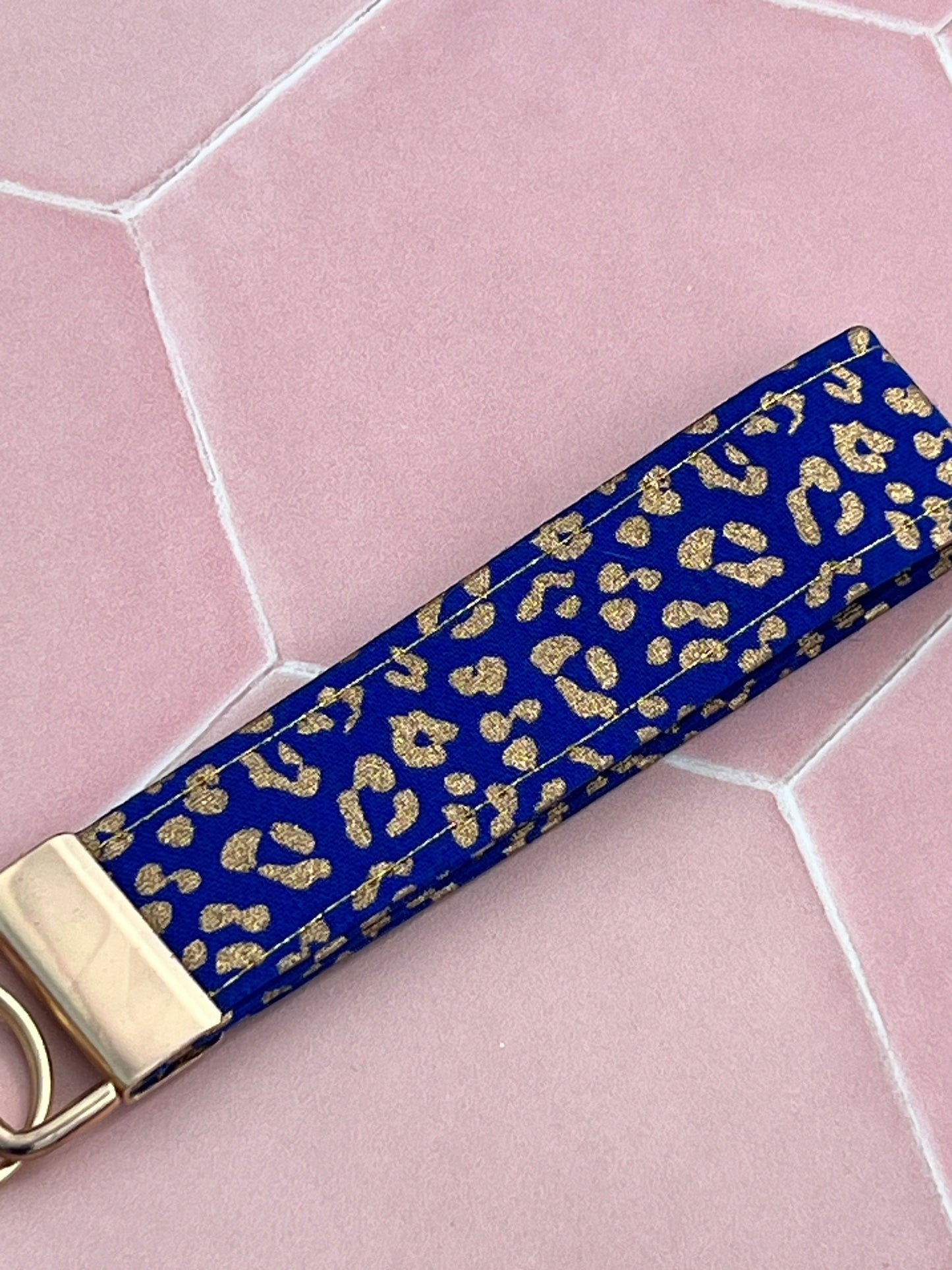 Sew Much Love blue and gold leopard print cotton wristlet keychain with gold hardware. Handmade and durable.