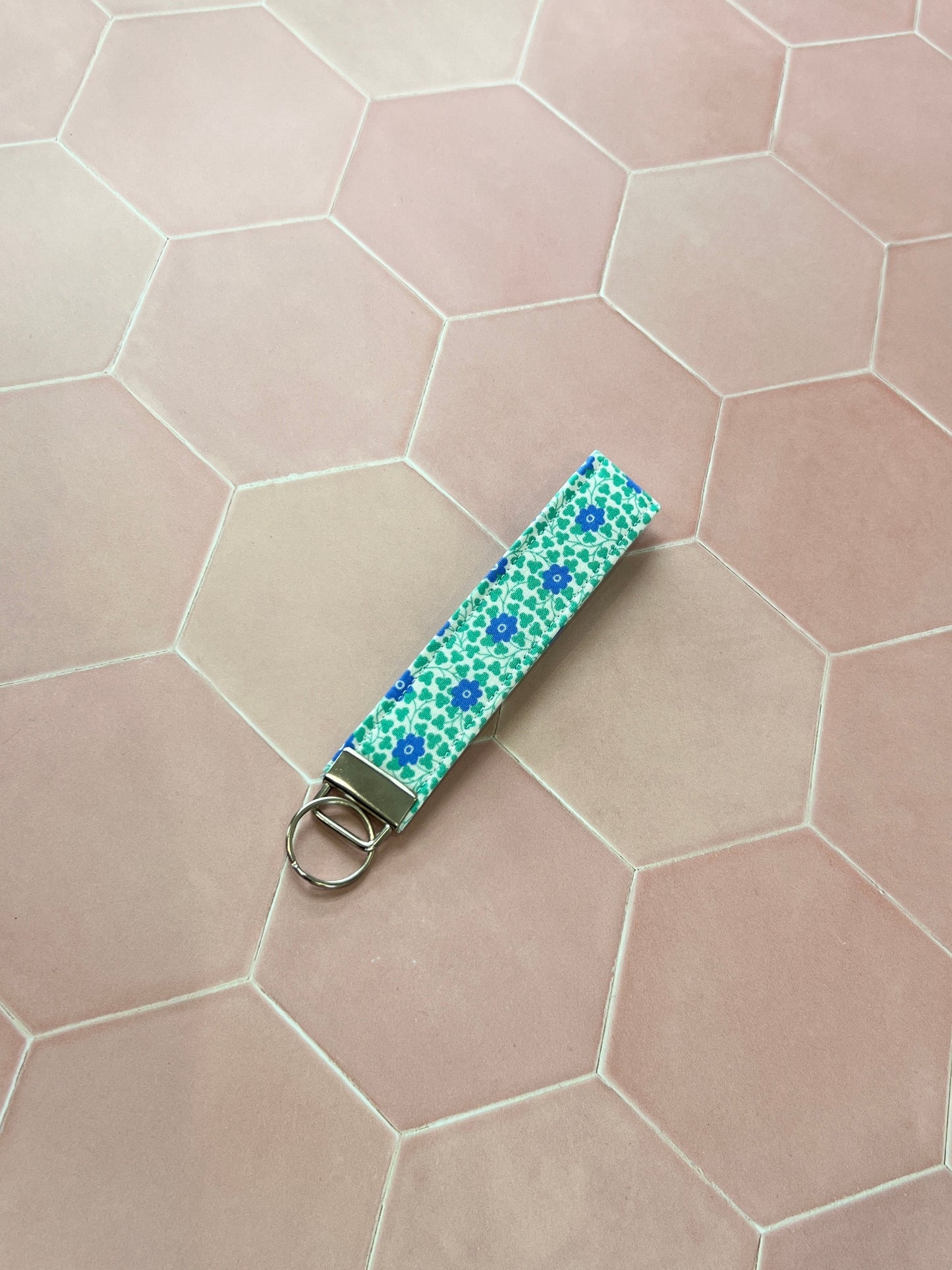 Sew Much Love blue and green floral cotton wristlet keychain with silver hardware.
