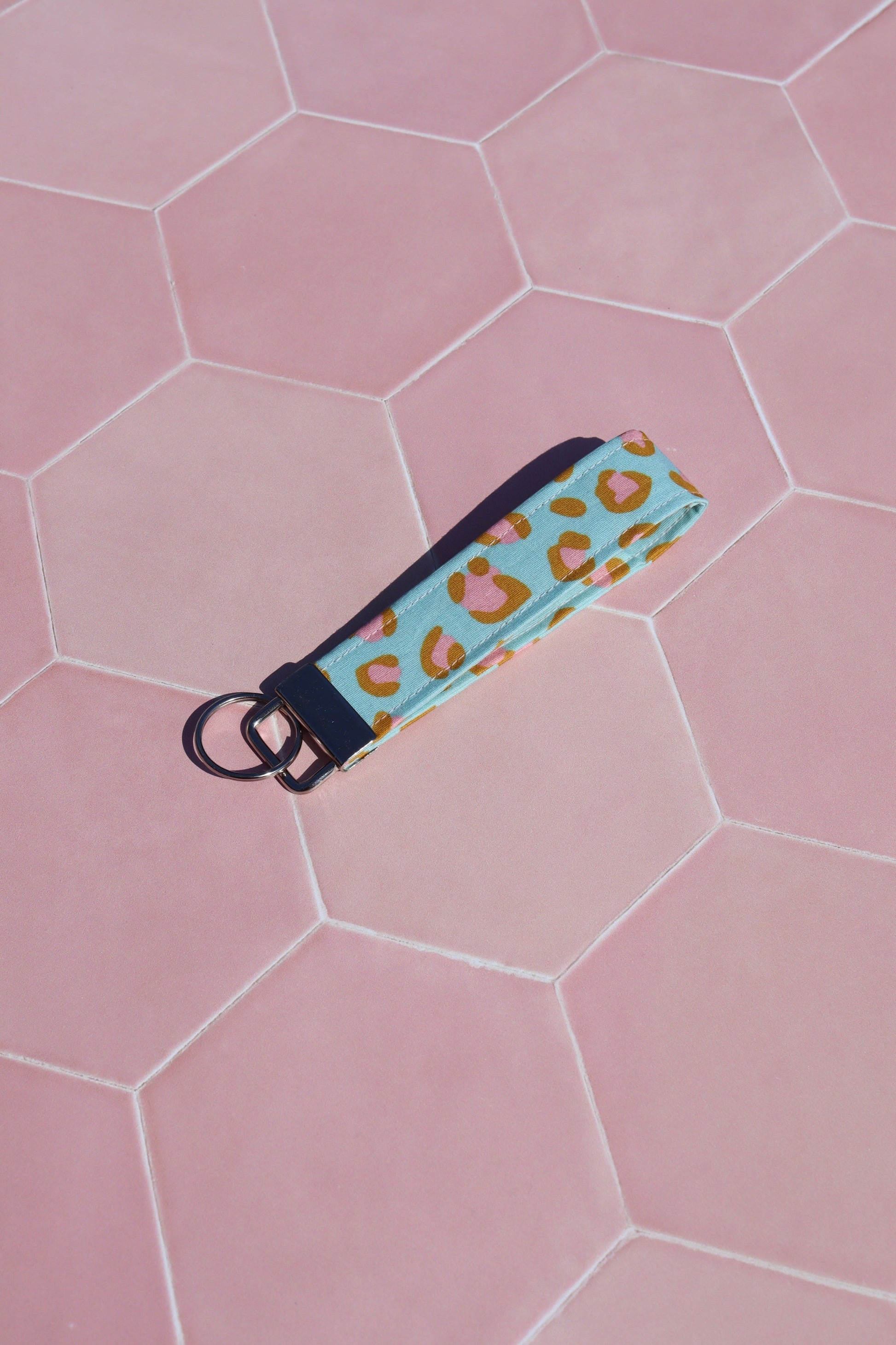 Sew Much Love blue and pink leopard print cotton wristlet keychain with gold hardware.