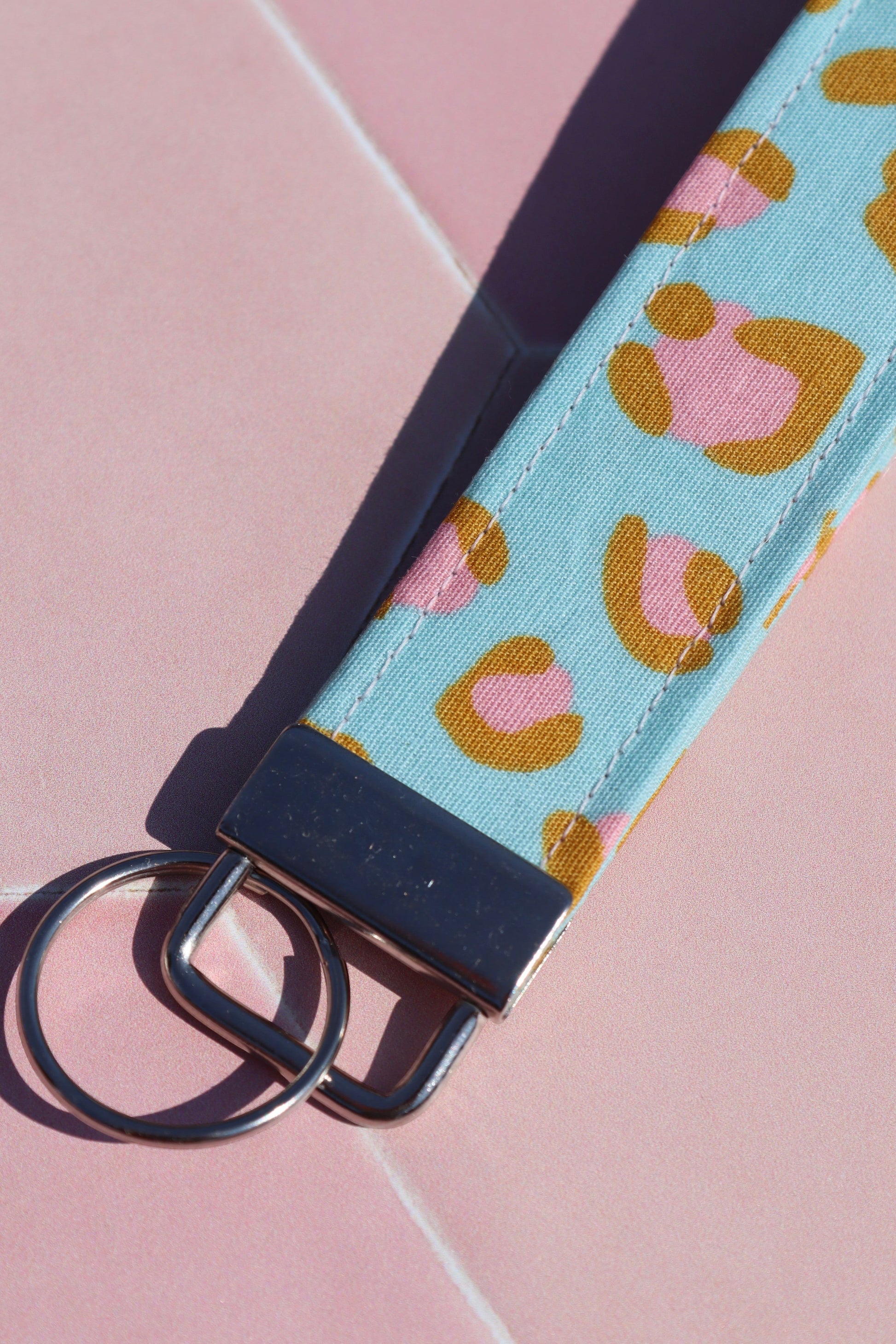 Sew Much Love blue and pink leopard print cotton wristlet keychain with silver hardware.