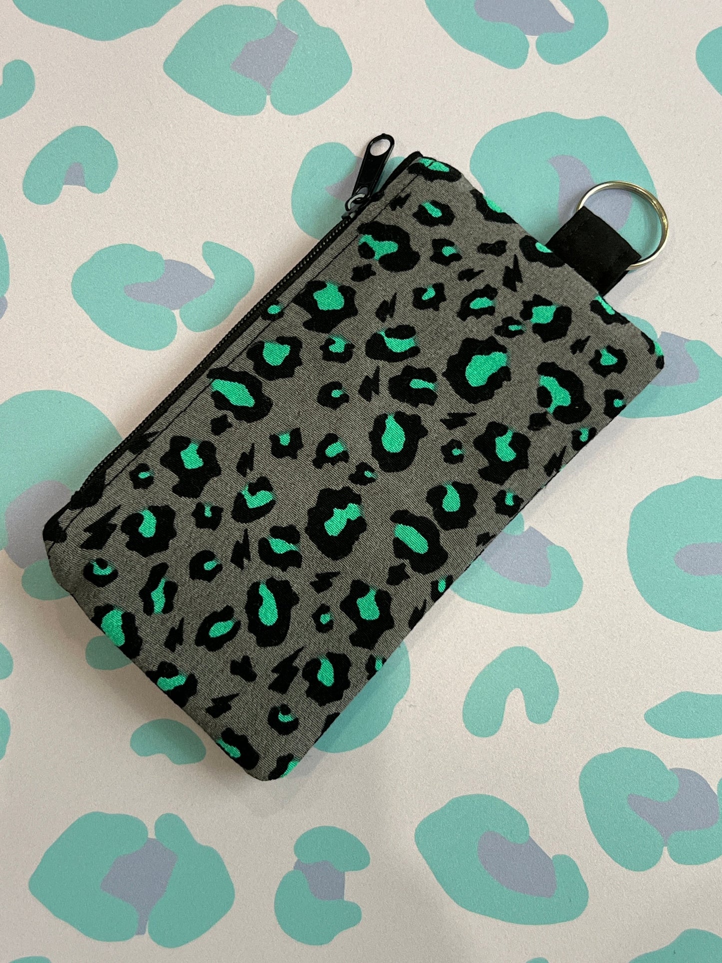 Sew Much Love grey coin purse with black and bright green leopard print and keyring attachment.