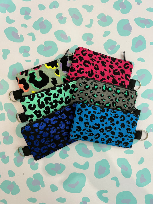 Sew Much Love handmade leopard print coin purses in various colors: pink, mint green, grey, blue, and multi-color. Features a keyring attachment.