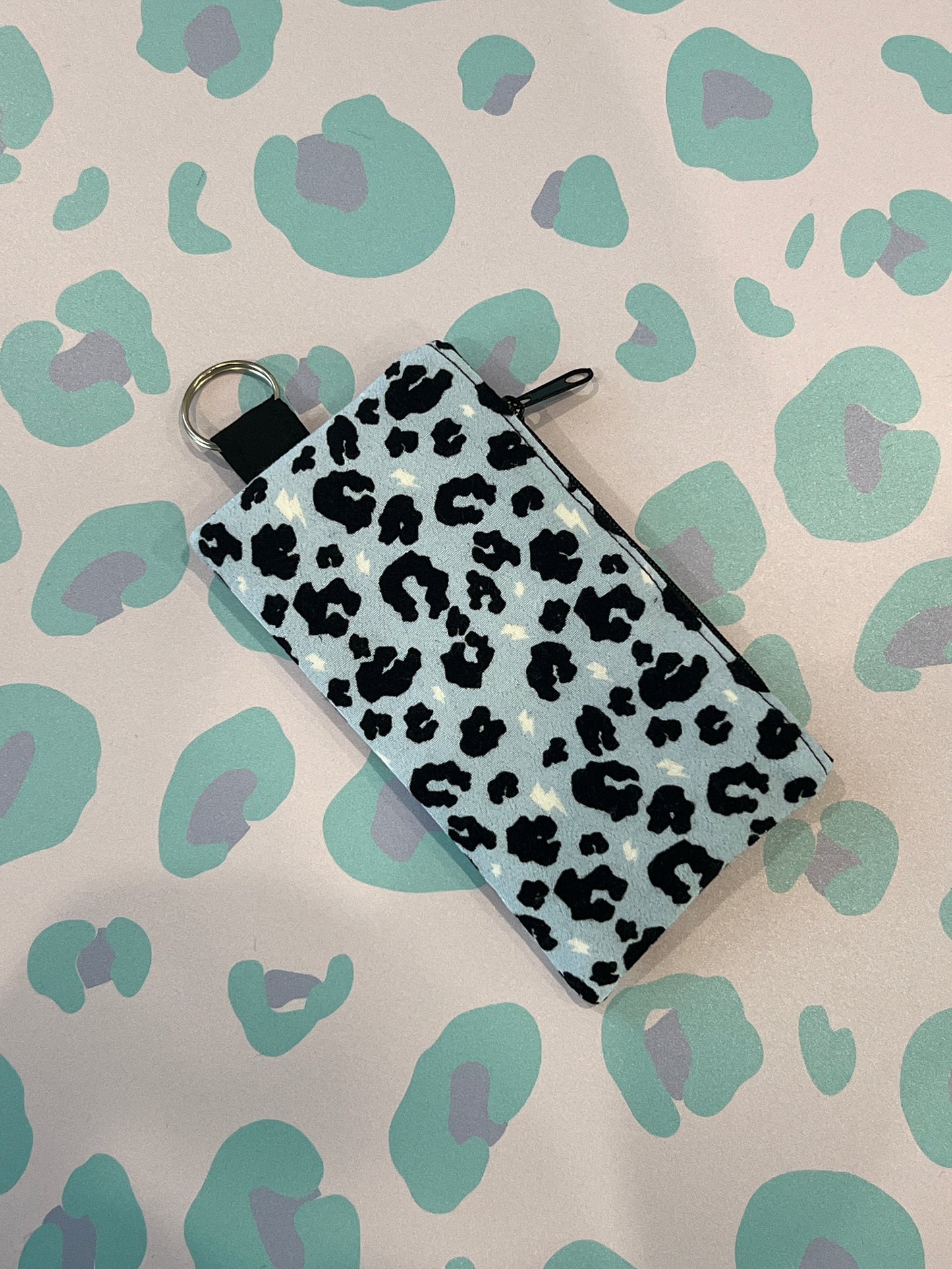 Sew Much Love light blue leopard print coin purse with black zipper and keyring attachment.