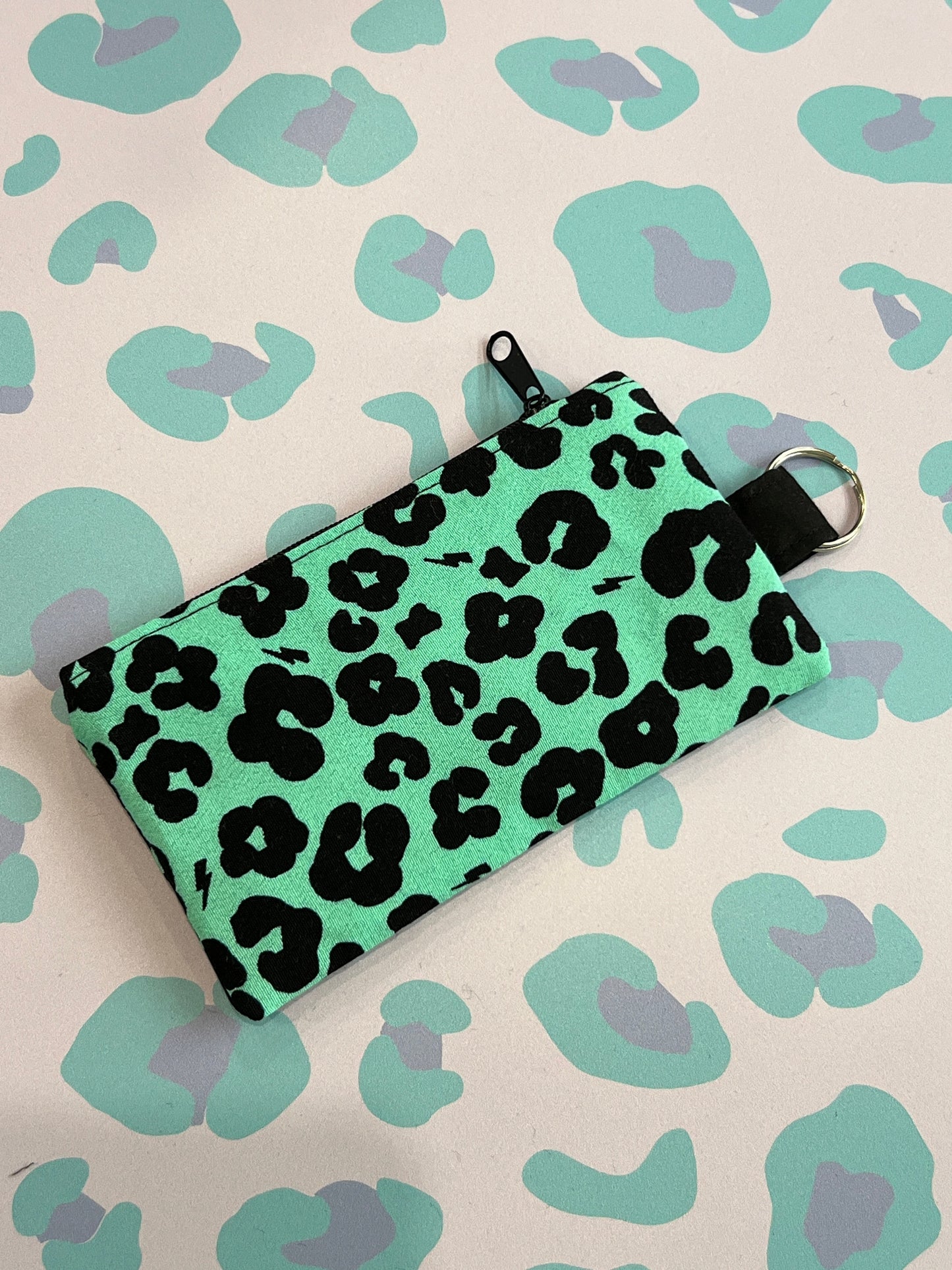 Sew Much Love green coin purse with black leopard print and lightning bolts, black zip, keyring attachment.