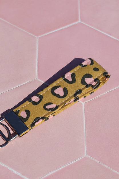 Sew Much Love mustard yellow cotton wristlet keychain with pink and black leopard print and silver hardware.