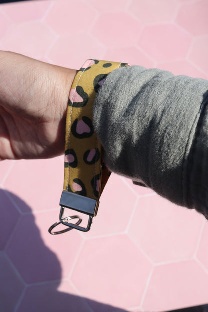 Sew Much Love mustard yellow cotton wristlet keychain with pink and black leopard print and silver hardware.