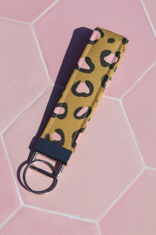Sew Much Love mustard yellow cotton wristlet keychain with pink and black leopard print and silver hardware.