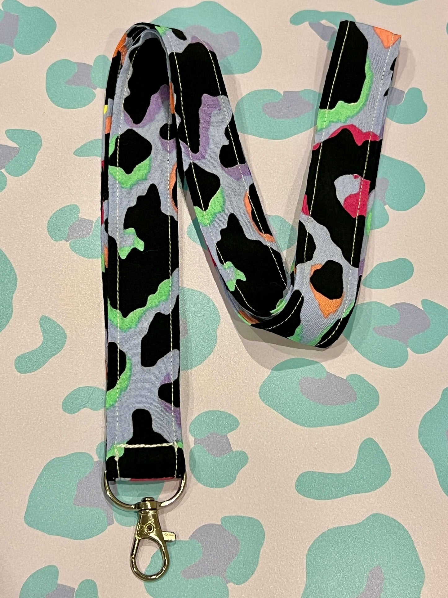 Sew Much Love light blue lanyard with a vibrant rainbow leopard print pattern and a silver clasp. Made from soft eco viscose.